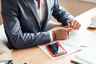 person in suit at desk