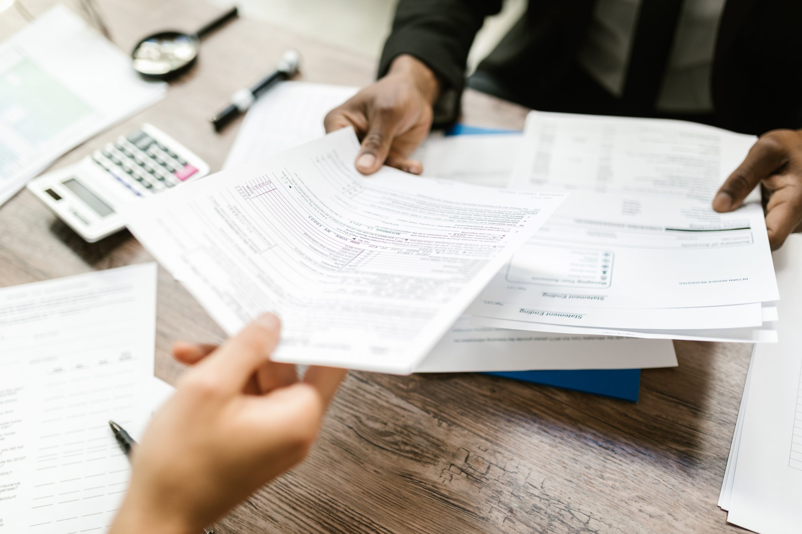 Hands taking financial documents